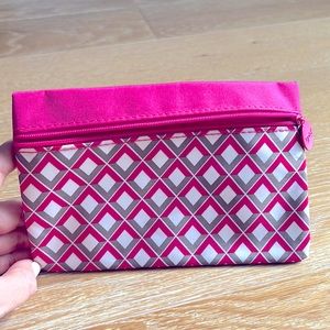 Pink cosmetic bag with diamond shape design.